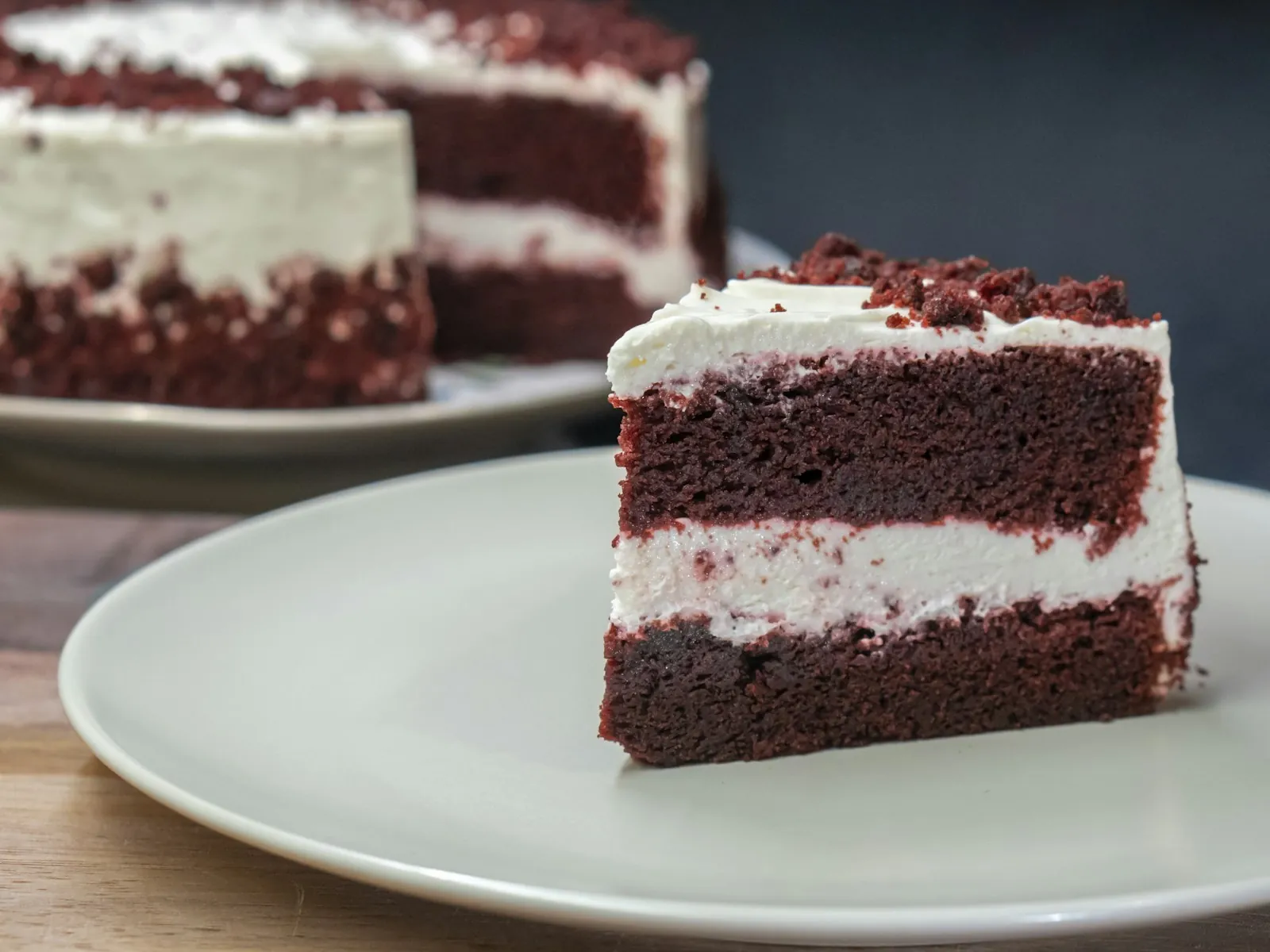 Slices of cocoa red velvet cake layered with cream cheese frosting